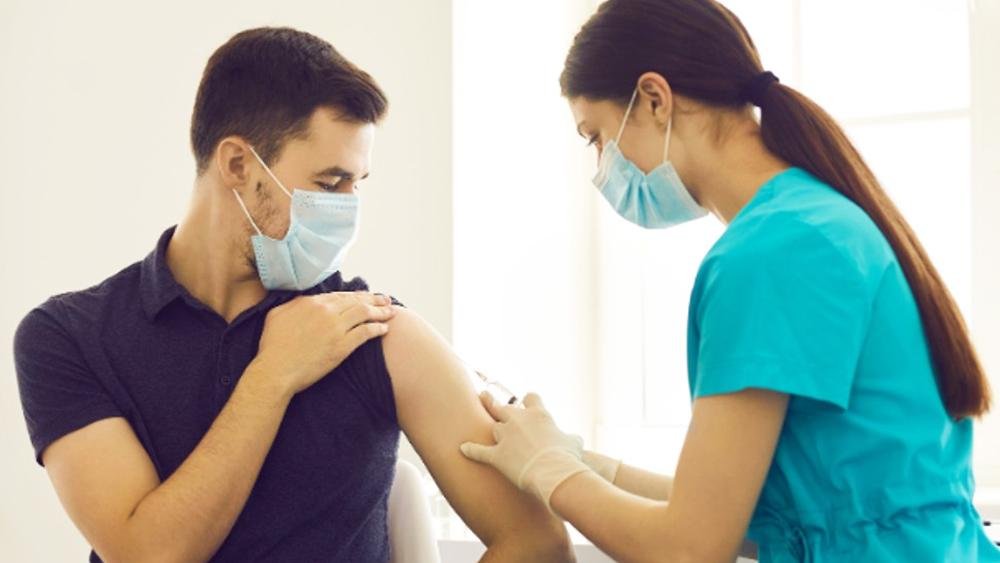 Healthcare professional providing vaccination at home in Dubai